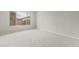 Cozy bedroom with neutral carpet, one window, and brick fence view at 17633 W Palo Verde Dr, Litchfield Park, AZ 85340