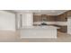Modern kitchen featuring granite countertops, stainless steel appliances, and a large center island at 17633 W Palo Verde Dr, Litchfield Park, AZ 85340
