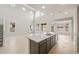Open-concept kitchen featuring a spacious island with sink and stainless steel appliances at 17633 W Palo Verde Dr, Litchfield Park, AZ 85340