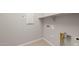 Functional laundry room with ample space, built-in shelving, and convenient utility connections at 17633 W Palo Verde Dr, Litchfield Park, AZ 85340