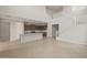 Bright, open living area with soaring ceilings, connecting seamlessly to the modern kitchen and staircase at 17633 W Palo Verde Dr, Litchfield Park, AZ 85340