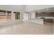 Spacious living area with tile flooring, large windows, and an open layout connecting to the kitchen at 17633 W Palo Verde Dr, Litchfield Park, AZ 85340
