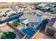 Aerial view of a home showcasing a backyard oasis with a pool, covered patio and lush, green landscaping at 17962 W Elm St, Goodyear, AZ 85395