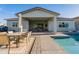 Inviting backyard with a covered patio, outdoor dining, a pool and lounging chairs at 17962 W Elm St, Goodyear, AZ 85395