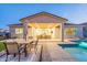Beautiful backyard with a refreshing pool, outdoor dining area and covered patio with an inviting fire pit at 17962 W Elm St, Goodyear, AZ 85395