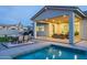 Inviting backyard featuring a pool, patio with outdoor seating and a cozy fire pit under a covered area at 17962 W Elm St, Goodyear, AZ 85395