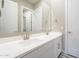 Bathroom featuring double sinks, countertops, and an open doorway to bathroom at 17962 W Elm St, Goodyear, AZ 85395