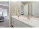 Bathroom featuring double sinks, countertops, and an open doorway at 17962 W Elm St, Goodyear, AZ 85395