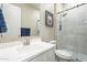 Modern bathroom showcases a vanity with sink, mirror, and tiled shower with glass door at 17962 W Elm St, Goodyear, AZ 85395