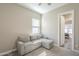 Relaxing room showcasing a comfortable sofa with access to an open doorway at 17962 W Elm St, Goodyear, AZ 85395