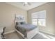 Cozy bedroom featuring a comfy bed, ceiling fan and a bright window view at 17962 W Elm St, Goodyear, AZ 85395