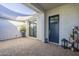 Inviting courtyard with brick pavers, potted plants, shade covering, and a charming entrance at 17962 W Elm St, Goodyear, AZ 85395