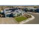 Charming home featuring solar panels, a well-manicured lawn, paver driveway, and lush landscaping at 17962 W Elm St, Goodyear, AZ 85395