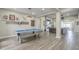 Recreation room features a pool table and views to both the living room and backyard at 17962 W Elm St, Goodyear, AZ 85395