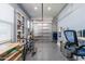 Bright garage with epoxy floors, open shelving, natural light, and an updated garage door at 17962 W Elm St, Goodyear, AZ 85395