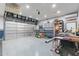 Spacious garage with ample storage space, blue cabinets, workbench, and epoxy flooring at 17962 W Elm St, Goodyear, AZ 85395