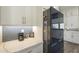 Well-lit kitchen features a herringbone tile backsplash, quartz counters, and stainless steel appliances at 17962 W Elm St, Goodyear, AZ 85395