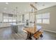 Open concept kitchen with island seating, modern appliances, and stylish pendant lighting at 17962 W Elm St, Goodyear, AZ 85395