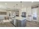 Spacious kitchen with a large island, stainless steel appliances, and open concept design at 17962 W Elm St, Goodyear, AZ 85395