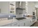 Modern kitchen featuring white cabinets, quartz countertops, and stainless steel appliances at 17962 W Elm St, Goodyear, AZ 85395
