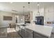 Gourmet kitchen boasts a large island with a stainless steel sink and pendant lighting at 17962 W Elm St, Goodyear, AZ 85395