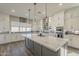 Bright kitchen featuring a large island, stainless appliances, and a tiled backsplash at 17962 W Elm St, Goodyear, AZ 85395