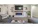 Stylish living room features a linear fireplace, mounted TV, and modern shelving at 17962 W Elm St, Goodyear, AZ 85395