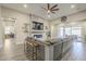 Open living room with a modern fireplace, a large sectional sofa, and access to patio at 17962 W Elm St, Goodyear, AZ 85395