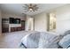 Spacious main bedroom with television, furnishings and access to the en suite bathroom and other rooms at 17962 W Elm St, Goodyear, AZ 85395