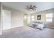Large main bedroom featuring neutral walls and carpets and an attached bathroom with tiled shower at 17962 W Elm St, Goodyear, AZ 85395