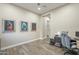 Office with wood like tile and decorative paintings on the wall at 17962 W Elm St, Goodyear, AZ 85395