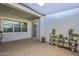 Tranquil patio with a window, neutral stucco, and potted plants on display at 17962 W Elm St, Goodyear, AZ 85395