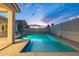 Backyard with a gorgeous sparkling pool, inviting lounge chairs, and lush landscaping for ultimate relaxation at 17962 W Elm St, Goodyear, AZ 85395