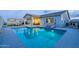 Inviting backyard featuring a sparkling pool, covered patio, and lounge chairs, perfect for outdoor relaxation at 17962 W Elm St, Goodyear, AZ 85395