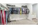 Spacious walk-in closet with ample hanging space, built-in shelving, and a view of the bathroom at 17962 W Elm St, Goodyear, AZ 85395