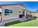 Expansive backyard featuring covered patio and well-maintained landscaping with lush green lawn at 17988 W Deneen Way, Surprise, AZ 85374