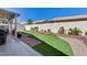 Well maintained backyard with manicured landscaping, flower beds, and outdoor seating at 17988 W Deneen Way, Surprise, AZ 85374
