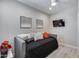 Comfortable bedroom with a daybed, black bedding, gray walls, and a mounted TV for relaxation at 17988 W Deneen Way, Surprise, AZ 85374