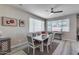 Bright dining room with a modern table set and natural light from the large windows at 17988 W Deneen Way, Surprise, AZ 85374