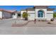 Charming home featuring desert landscaping, a concrete driveway, and an inviting exterior with unique architectural details at 17988 W Deneen Way, Surprise, AZ 85374