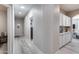 Bright hallway with white trim, light wood floors, and built-in white cabinets offers ample storage space at 17988 W Deneen Way, Surprise, AZ 85374