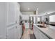 Bright kitchen featuring white cabinets, stainless steel appliances, and quartz countertops with a breakfast bar at 17988 W Deneen Way, Surprise, AZ 85374