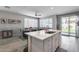 Bright kitchen island with stainless steel sink overlooking the adjacent dining area at 17988 W Deneen Way, Surprise, AZ 85374