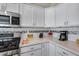 Kitchen featuring stainless steel appliances, quartz countertops, white cabinets, and subway tile backsplash at 17988 W Deneen Way, Surprise, AZ 85374