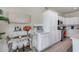 Kitchen featuring white cabinets, stainless steel appliances, quartz countertops, and a beverage cart at 17988 W Deneen Way, Surprise, AZ 85374