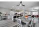 Open layout with dining area, island seating, and bright white kitchen cabinets at 17988 W Deneen Way, Surprise, AZ 85374