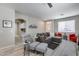Living room boasts modern furniture and decor, with stylish gray couches and an accent wall at 17988 W Deneen Way, Surprise, AZ 85374