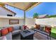 Inviting covered patio with outdoor seating and cozy fire pit, perfect for entertaining at 17988 W Deneen Way, Surprise, AZ 85374