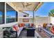 Inviting covered patio with fire pit, ample seating and views of the backyard at 17988 W Deneen Way, Surprise, AZ 85374