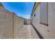 Narrow side yard with rock ground cover and partial view of the backyard at 17988 W Deneen Way, Surprise, AZ 85374